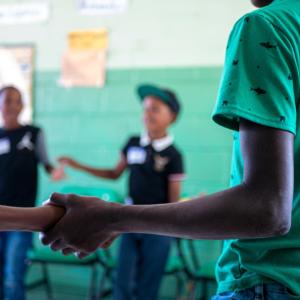 students holding hands in a circle