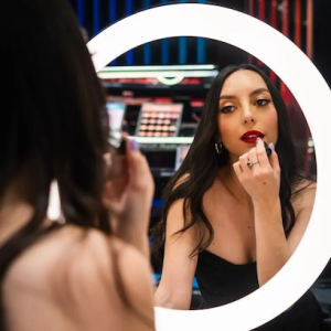 Camila applying lipstick.