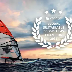 A windsurfer on a body of water. The seal for Canalys global sustainable ecosystems leadership and the Lenovo logo.
