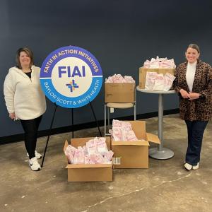 Two women standing next to boxes with gifts