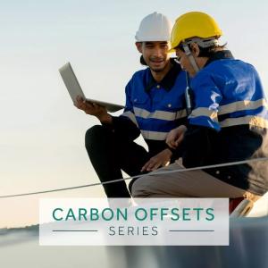Carbon Offsets Series: Two technicians working on a solar panel.