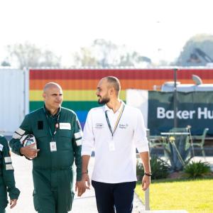 Three employees walking together outside