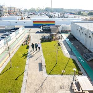 Three people walking outside, seen from above