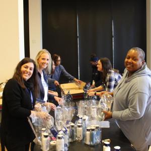 Bath & Body Works associates gather to support women transitioning from the program and into new homes by creating Bath & Body 