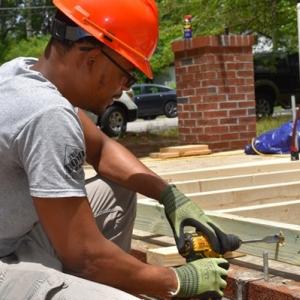 Photo collage showing construction workers building a home.