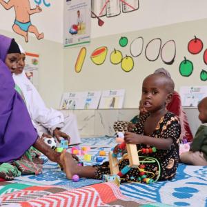 Caregivers and children connect at the IYCF and play area. 