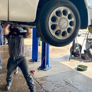 person working on a car up on a lift