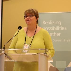 Cathy Glover talking into a microphone 