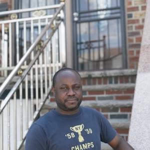 Resident standing in front of his home in NYC.