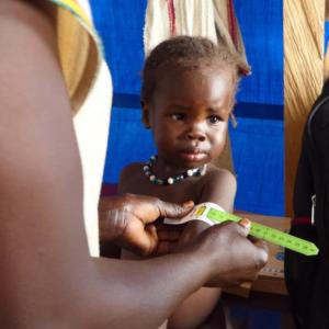 A child is screened for malnutrition.