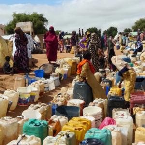 Displaced people in Chad wait for water.
