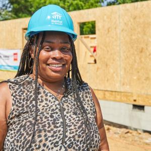 Habitat for Humanity homeowner Shaquawanda stands in front of the build site of her future home