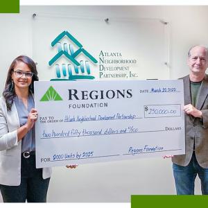 large display check held by two people