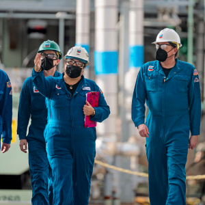 Chevron employees walk at processing plant