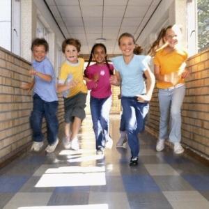 Children running down a hall in a school.