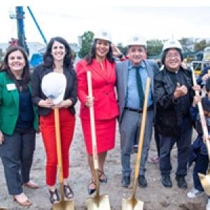 Lisa Gutierrez (green jacket) and Mayor London Breed (red dress) at the groundbreaking of an affordable housing development in San Francisco's Chinatown neighborhood.