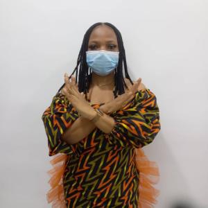 Woman in a colorful dress crossing her arms