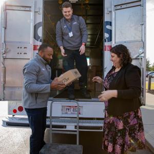 group putting boxes in Cintas truck
