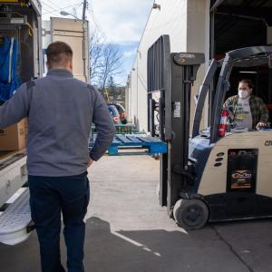 forklift putting boxes in truck