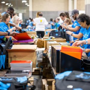 volunteers packing backpacks