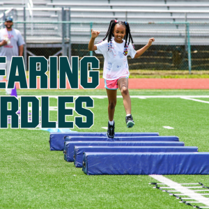 kid jumping hurdles