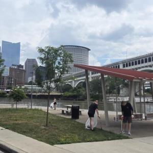 AEG employee volunteers gathered along the Cuyahoga River, armed with gloves and trash grabbers.