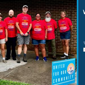 a group of seven people all wearing "day of action" t shirts. Whirlpool logo and United Way logo on the right