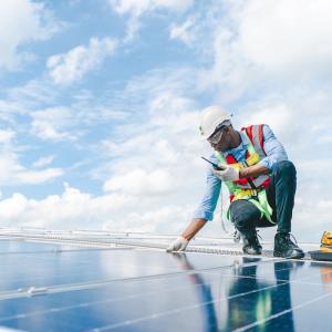 Wesco technician working on a solar panel array.