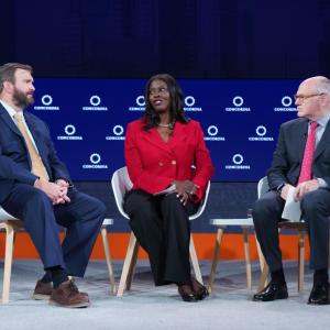 Three people sitting down and talking together