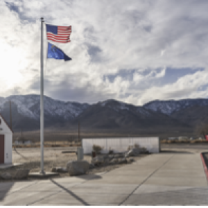 Flags flying with mountains in the background