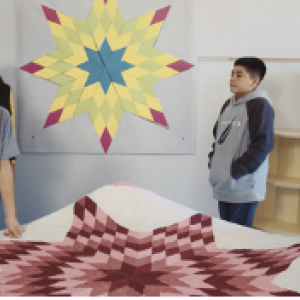 Students standing around colorful star design