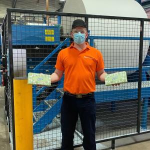 An employee holds Scott® tissues at Kimberly-Clark's Flint manufacturing facility in the UK.