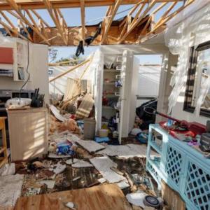 Three separate photos of volunteers helping to clear up, recover and restore buildings from the disaster caused by a hurricane  