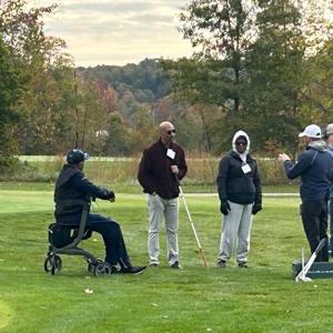 Participants, volunteers, and caregivers at the 2023 Stars, Stripes, and Links Event at Sand Ridge Golf Club in Chardon, Ohio.