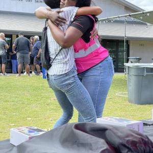 Community support, employee hugging a person in need