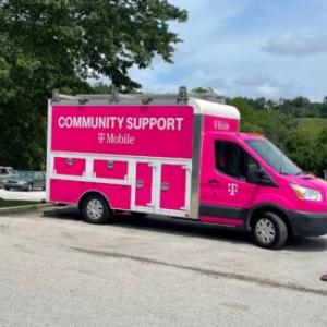 Pink TMobile "community support" van in a parking lot