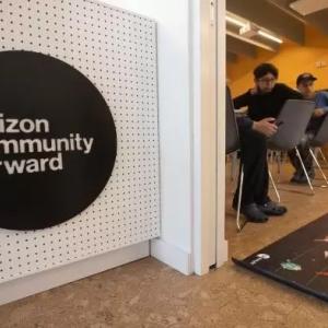 A Verizon Community Forward logo on a white wall