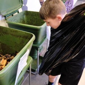 kid working on composting