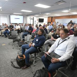 Phil Vavala speaking to a room of seated people.