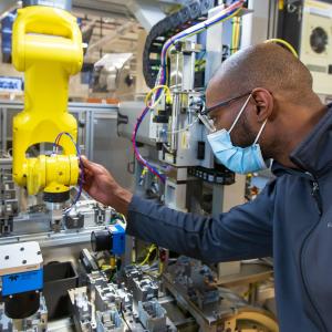 Worker at Rockwell Automation guiding machine