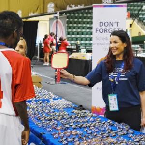 CooperVision employee holding mirror for child