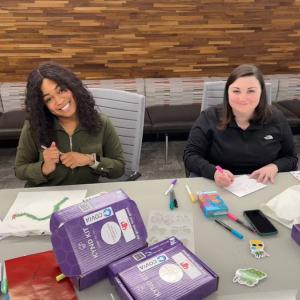 2 people at a table making cards