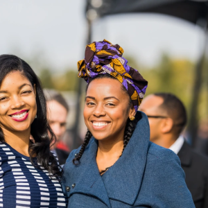 two smiling women in a crowd