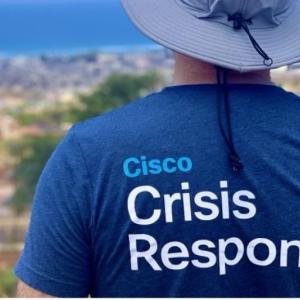 Back of person wearing a shirt that reads "Cisco Crisis Reponse"