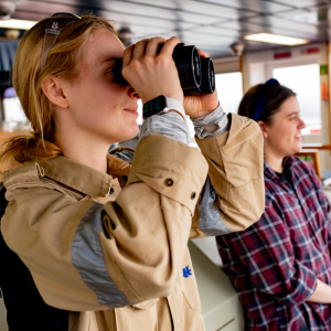 people looking out with binoculars