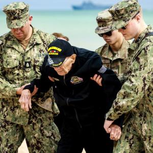People assisting a veteran  