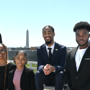 The Scholars posed outside. The Washington Monument in the distance.