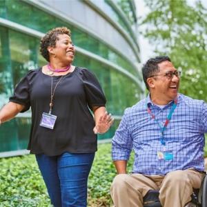 A diverse group of Merck KGaA, Darmstadt, Germany employees talking outside office