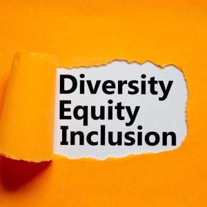 piece of orange paper pealed back in the middle, revealing text that reads "diversity equity inclusion"
