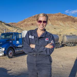 woman standing with truck in background 